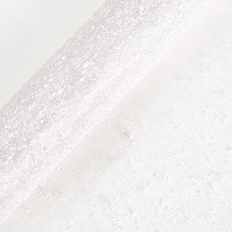 Close-up of a textured white fabric with a subtle pattern