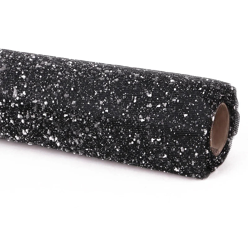 Roll of black glittery fabric on a white background